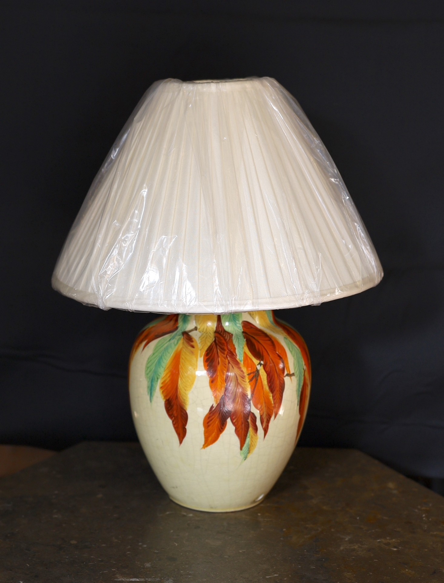 A 1930s English hand-painted pottery lamp base by Wait and Son of Midsham, Surrey, decorated with the autumn leaves, height without shade 27cm